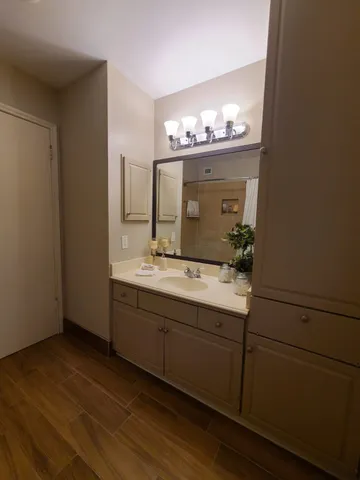 a bathroom with a sink a tub and a mirror