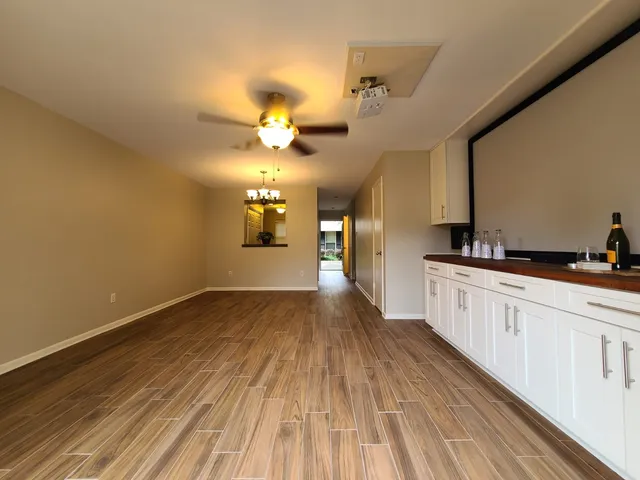 a view of a kitchen with a sink and wooden floor