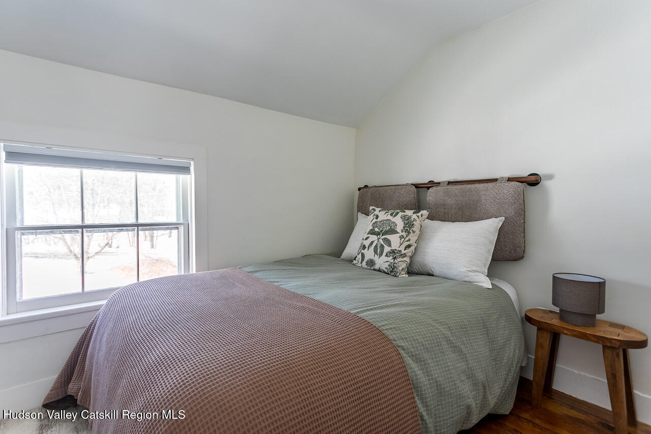 8 George Sickle Road Saugerties, NY 12477 - Photo 24 of 26 a large bed sitting in a bedroom next to a window