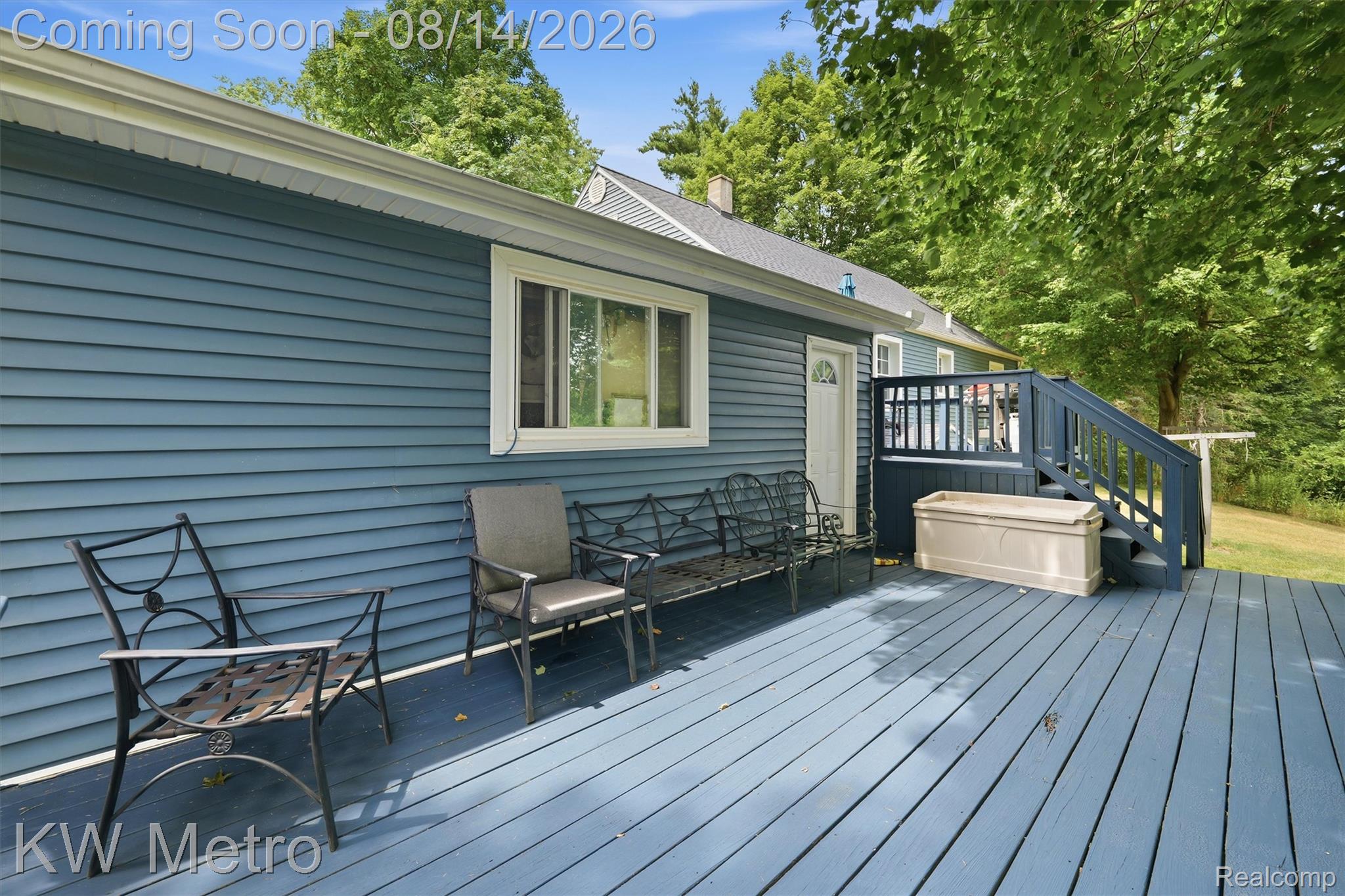 201 South Maple Leaf Road Lapeer, MI 48446 - Photo 33 of 70 Expansive outdoor deck with painted wood flooring and railings, featuring direct access to the interior