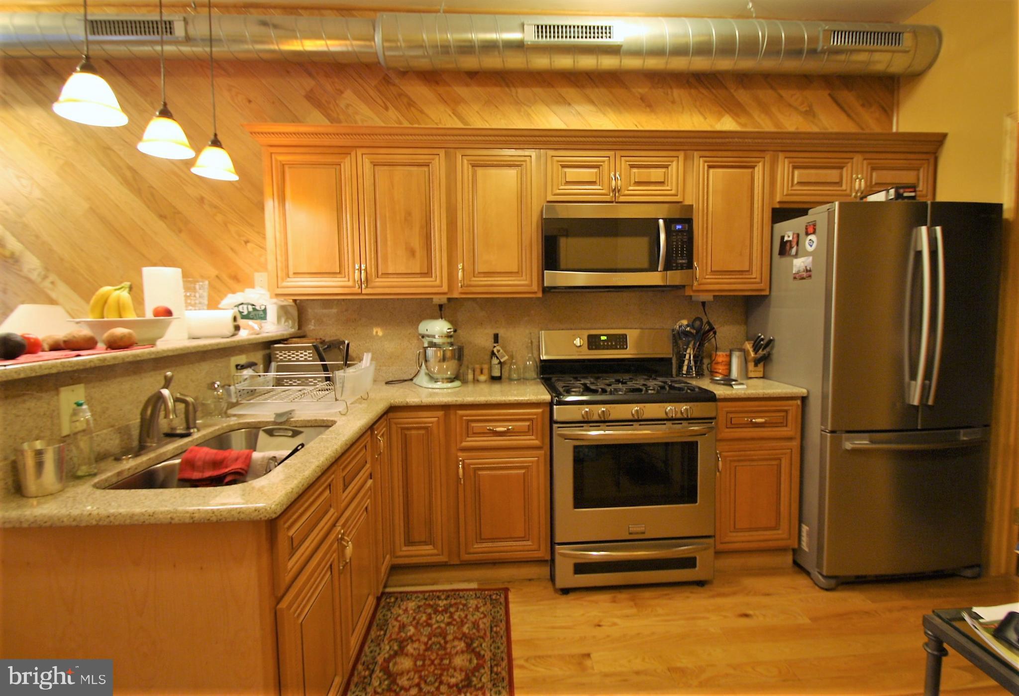 a kitchen with a refrigerator stove and sink