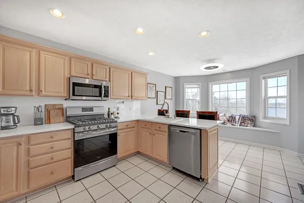 a kitchen with a stove sink and cabinets