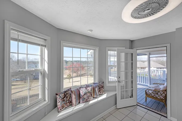 a spacious bedroom with a bed and glass door