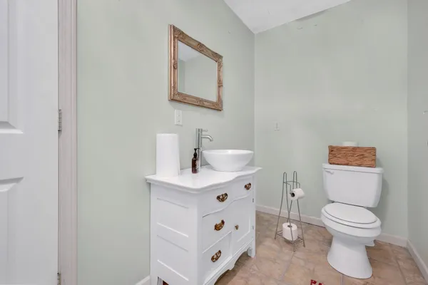 a white toilet sitting next to a bathroom sink