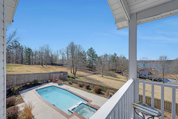a view of a balcony with yard