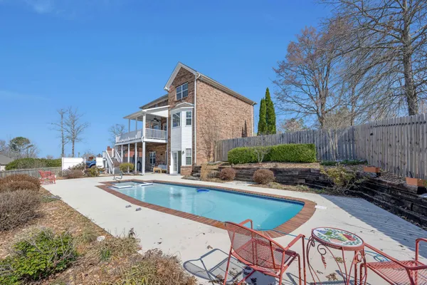 a view of swimming pool with outdoor seating and plants