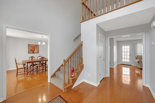 a view of a livingroom with furniture wooden floor and windows