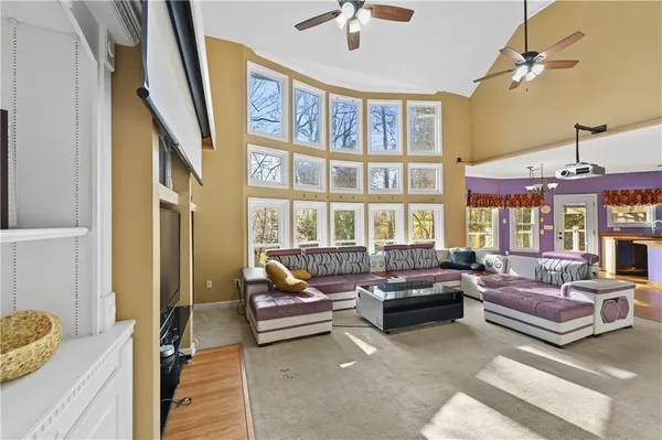 a living room with furniture and a floor to ceiling window