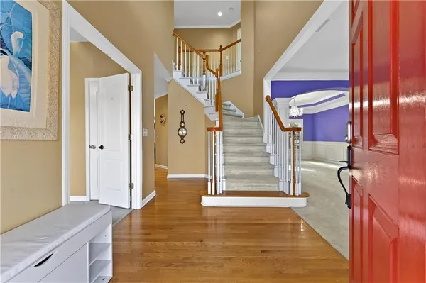 a view of entryway and hall with wooden floor