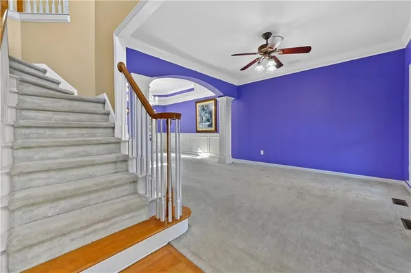 a view of an entryway with a floor to ceiling window and a chandelier