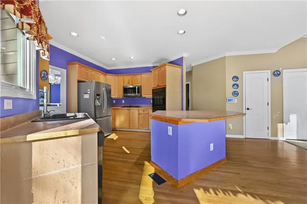 a kitchen with stainless steel appliances cabinets and a counter top space