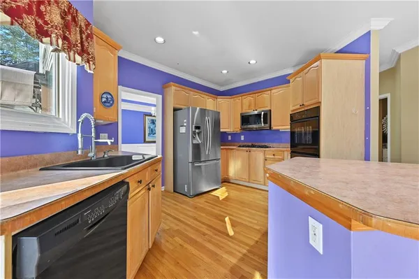 a kitchen with a refrigerator and a sink