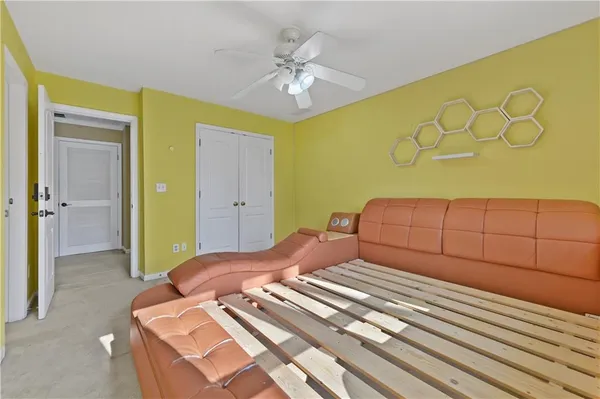 a view of a livingroom with a ceiling fan and window
