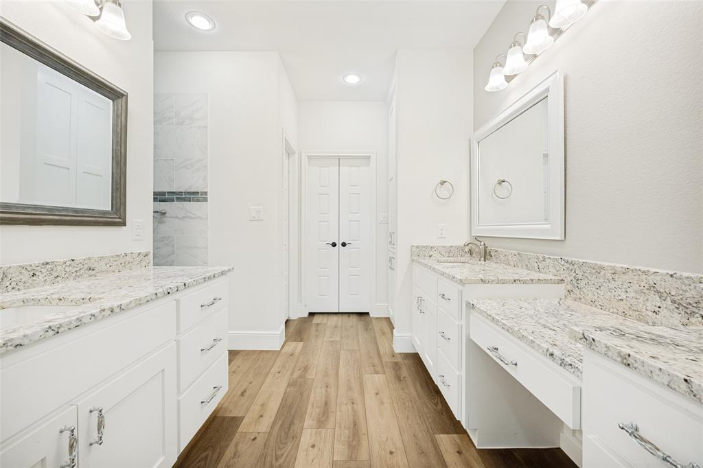 444 Ben Boyd Road Argyle, TX 76226 - Photo 19 of 28 a spacious bathroom with a granite countertop sink mirror and a