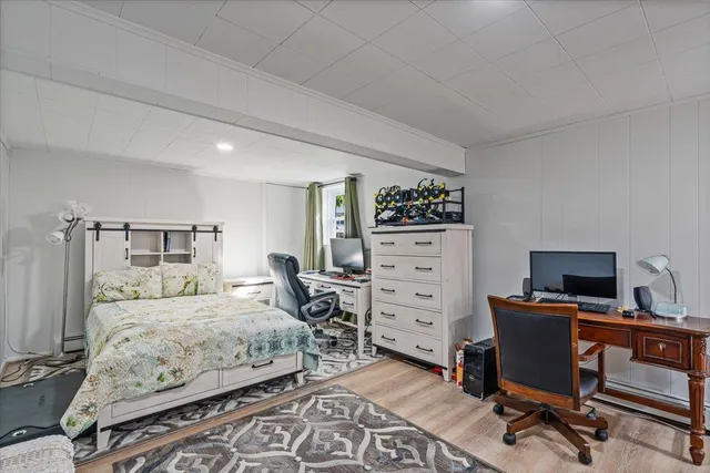 a bedroom with a bed and a desk