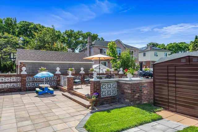 a view of a patio with table and chairs and potted plants