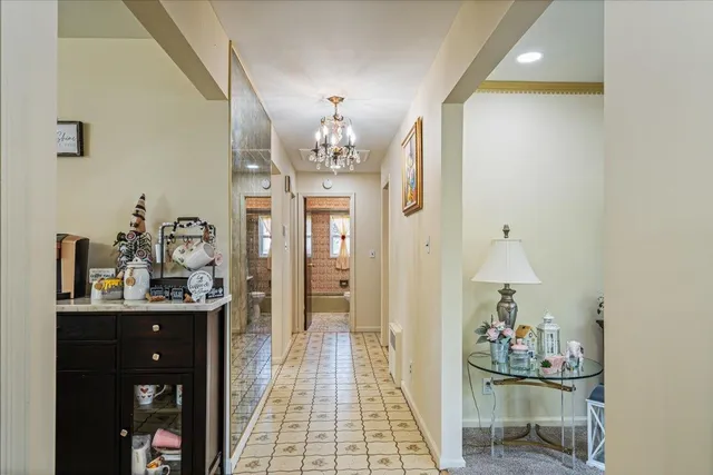 a dining room with furniture and chandelier