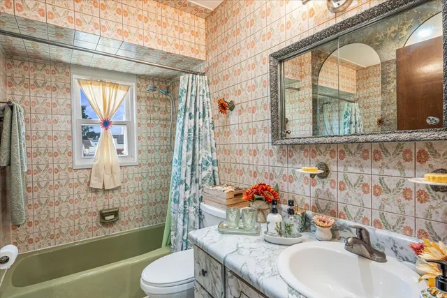 a bathroom with a granite countertop toilet sink and shower