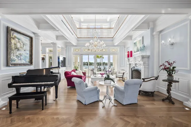 a living room with furniture kitchen view and a flat screen tv