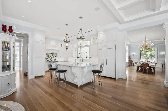 a spacious bedroom with a bed and a chandelier