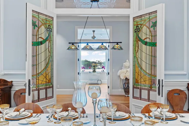 a bedroom with a large bed and wooden floor