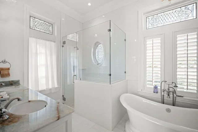 a living room with furniture a flat screen tv and a floor to ceiling window