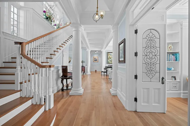 a bedroom with a large bed and a flat tv screen on dresser