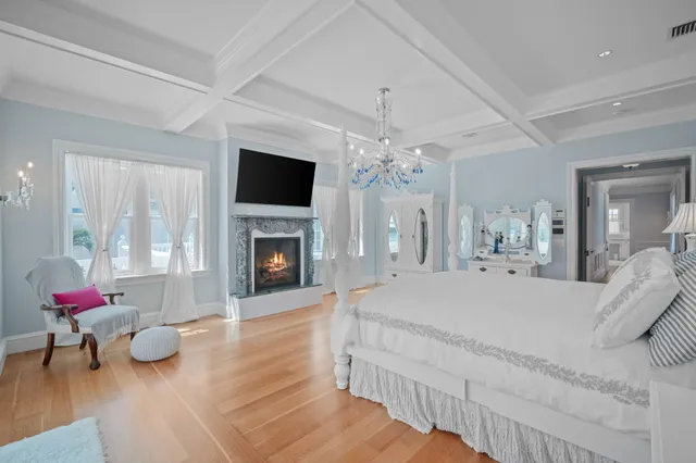 a view of a room with furniture and wooden floor