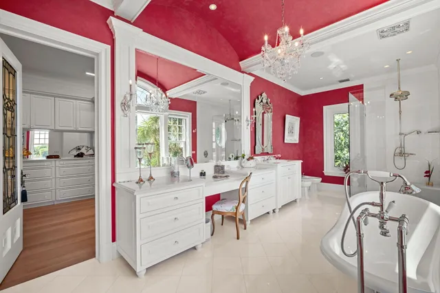 a kitchen with stainless steel appliances granite countertop a refrigerator a stove white cabinets and wooden floor