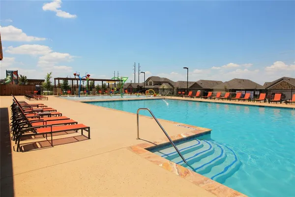 a view of a swimming pool with lounge chairs