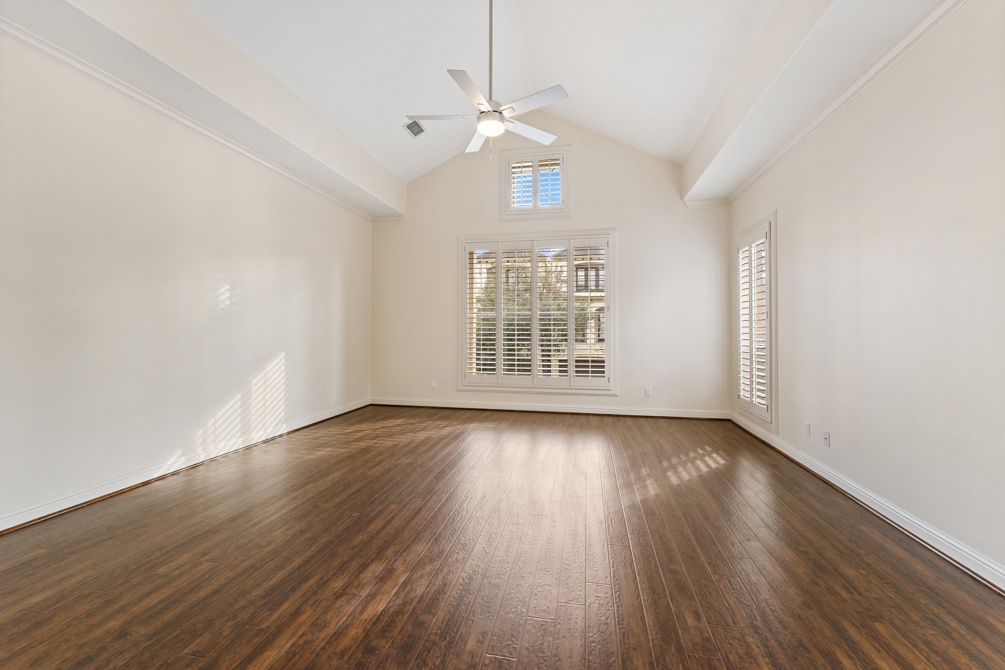 5422 Gibson Street, Unit A Houston, TX 77007 - Photo 18 of 42 Primary bedroom suite is on the second floor and features vaulted ceilings and custom shutters.