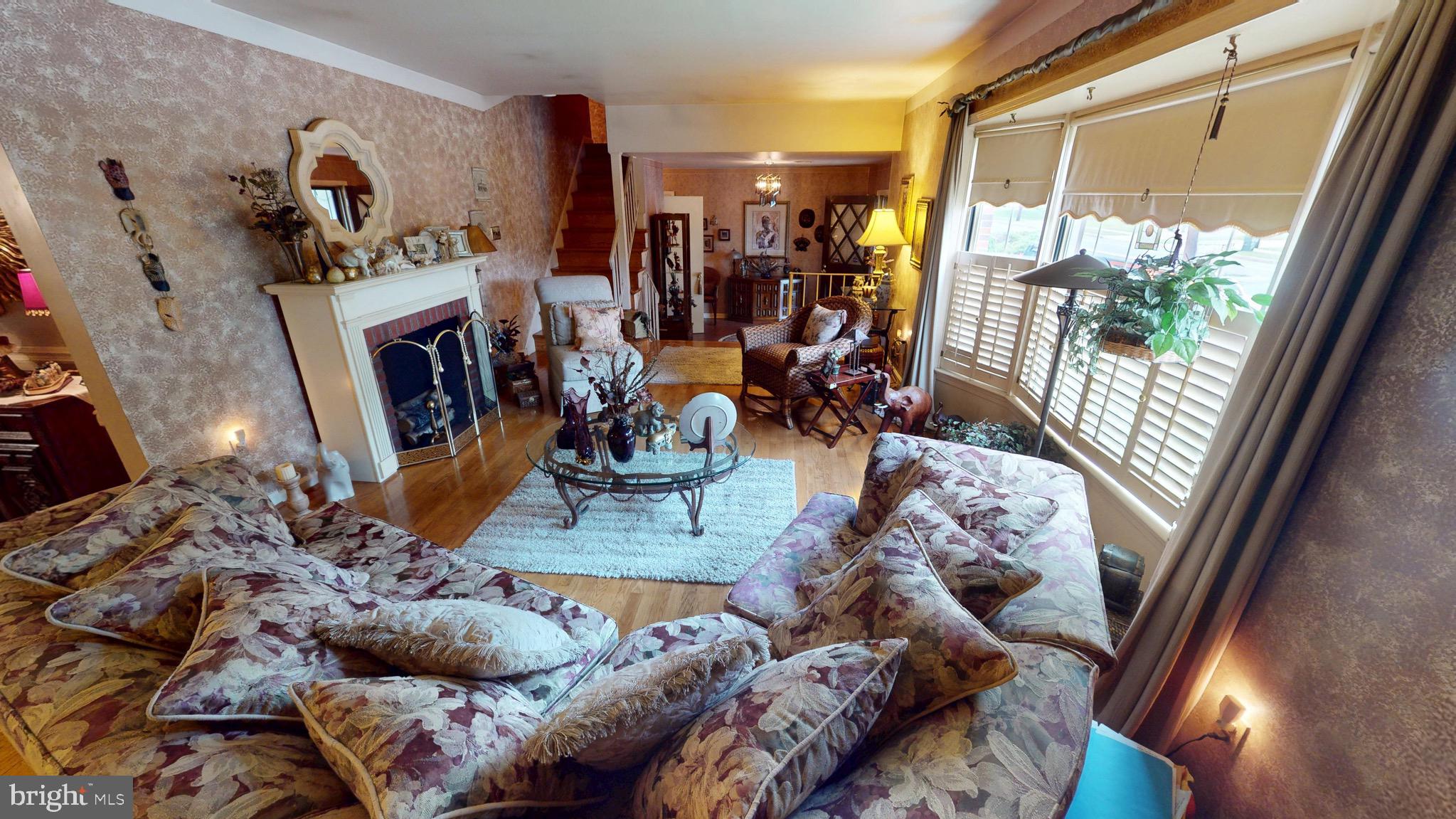 6911 Good Luck Road Hyattsville, MD 20784 - Photo 11 of 94 a living room with furniture and a floor to ceiling window