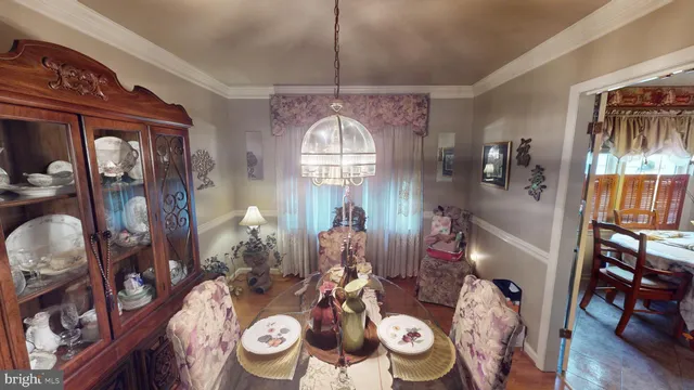 a view of a dining room with furniture and a flat screen tv