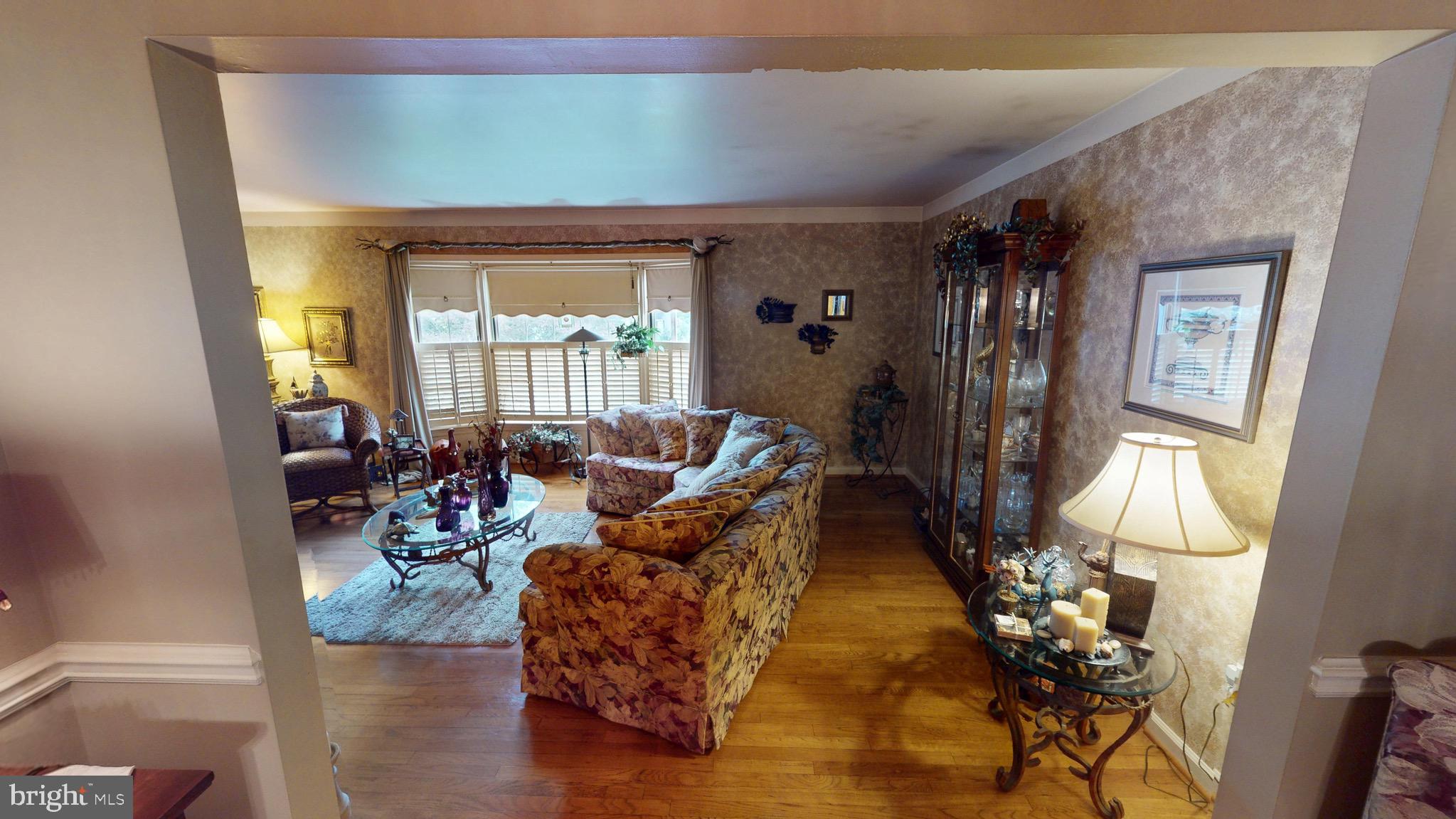 6911 Good Luck Road Hyattsville, MD 20784 - Photo 16 of 94 a living room with furniture and a large window