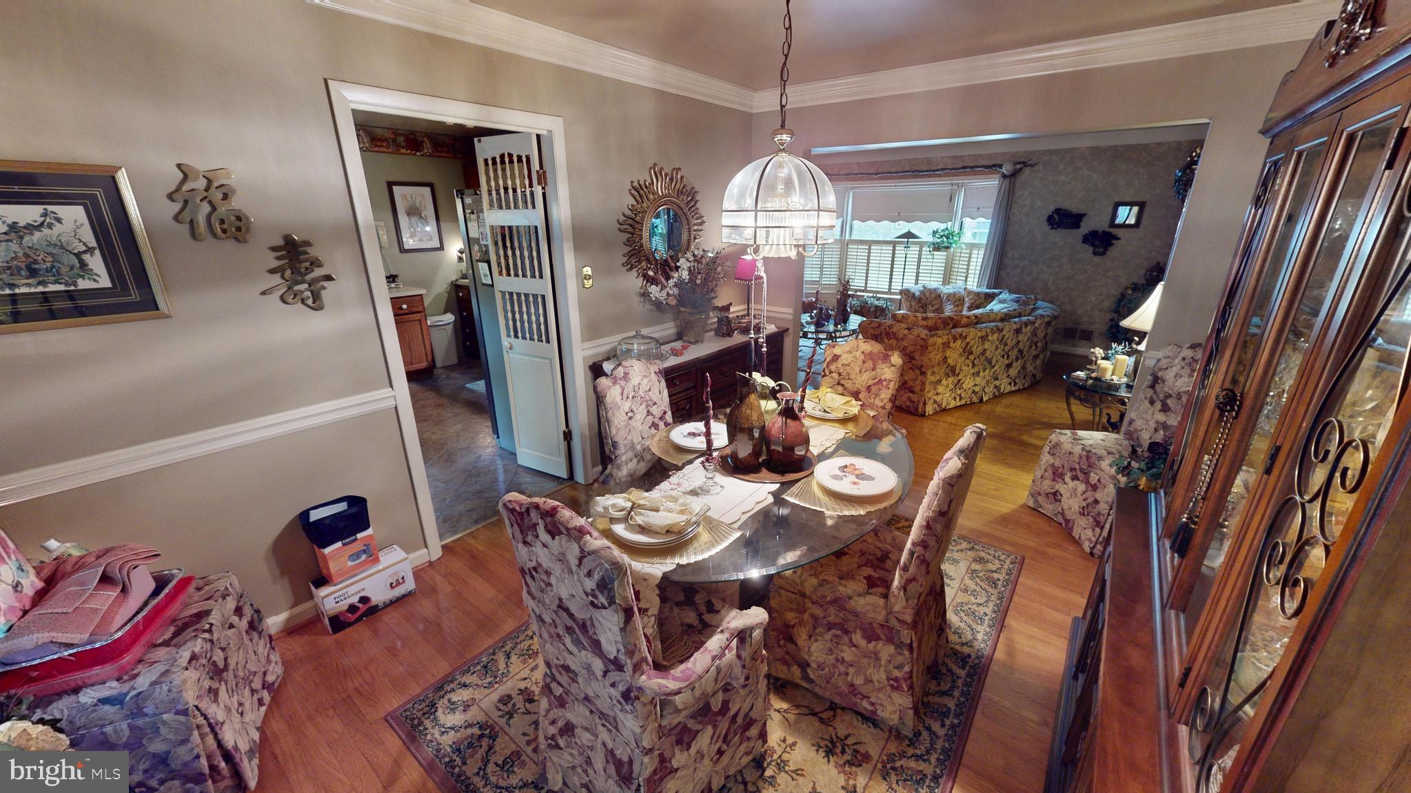 6911 Good Luck Road Hyattsville, MD 20784 - Photo 17 of 94 a view of a dining room with furniture and chandelier kitchen