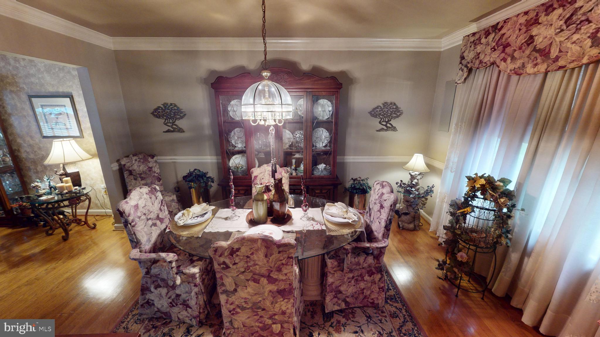 6911 Good Luck Road Hyattsville, MD 20784 - Photo 19 of 94 a view of a dining room with furniture and chandelier