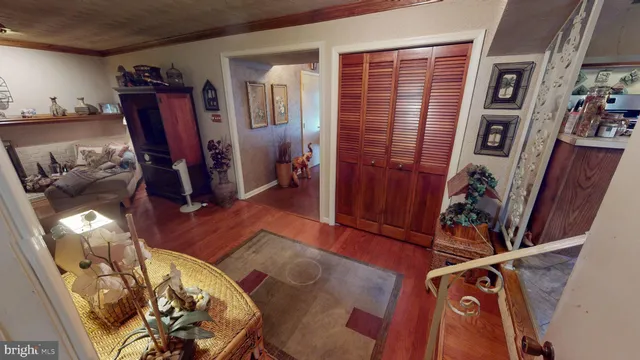 a view of entryway with wooden floor and stairs