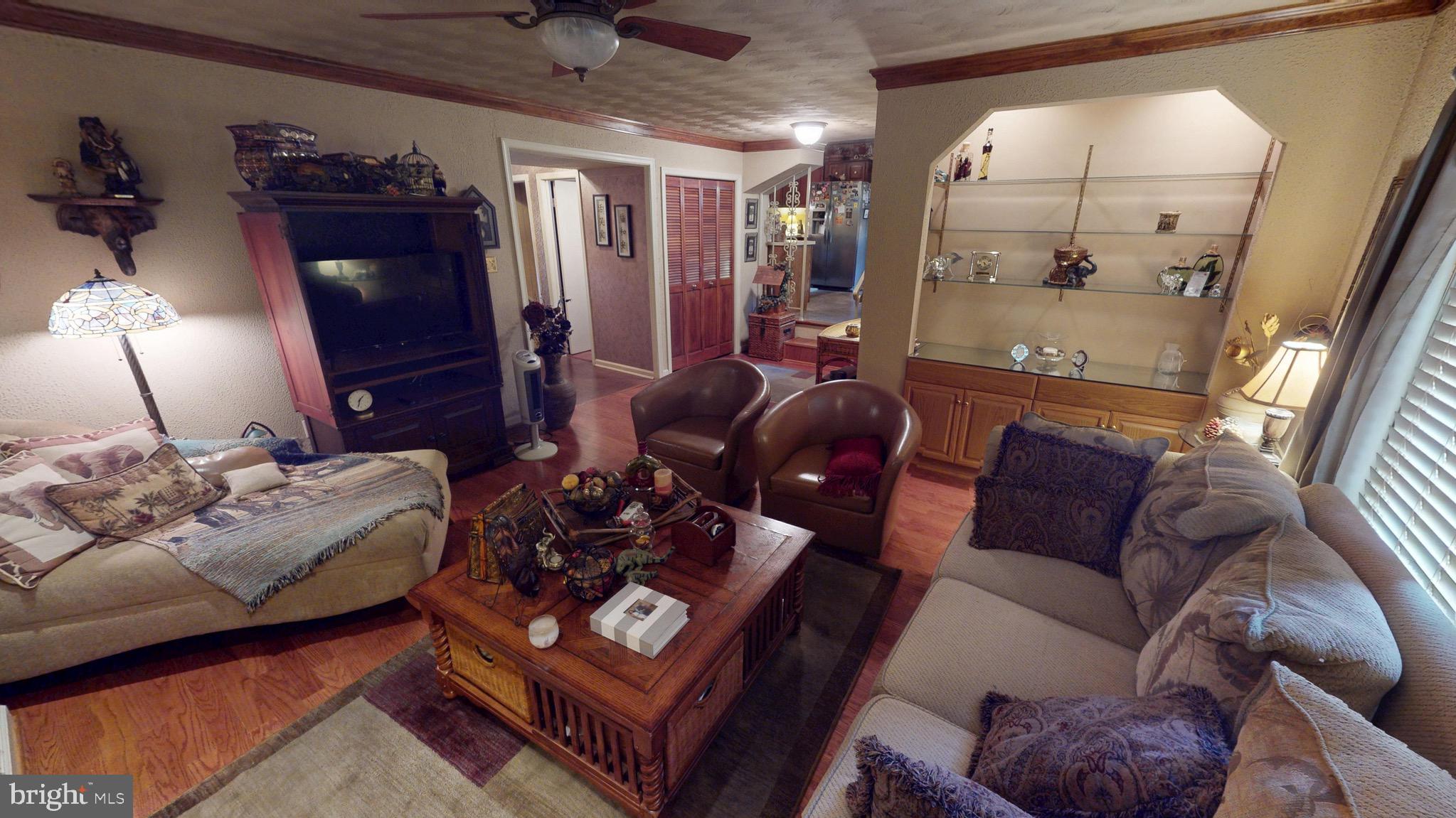 6911 Good Luck Road Hyattsville, MD 20784 - Photo 33 of 94 a living room with furniture and a lamp