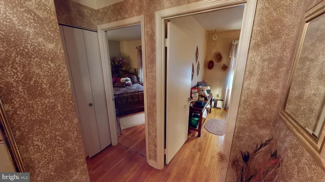 a bedroom with a bed and a mirror on dresser
