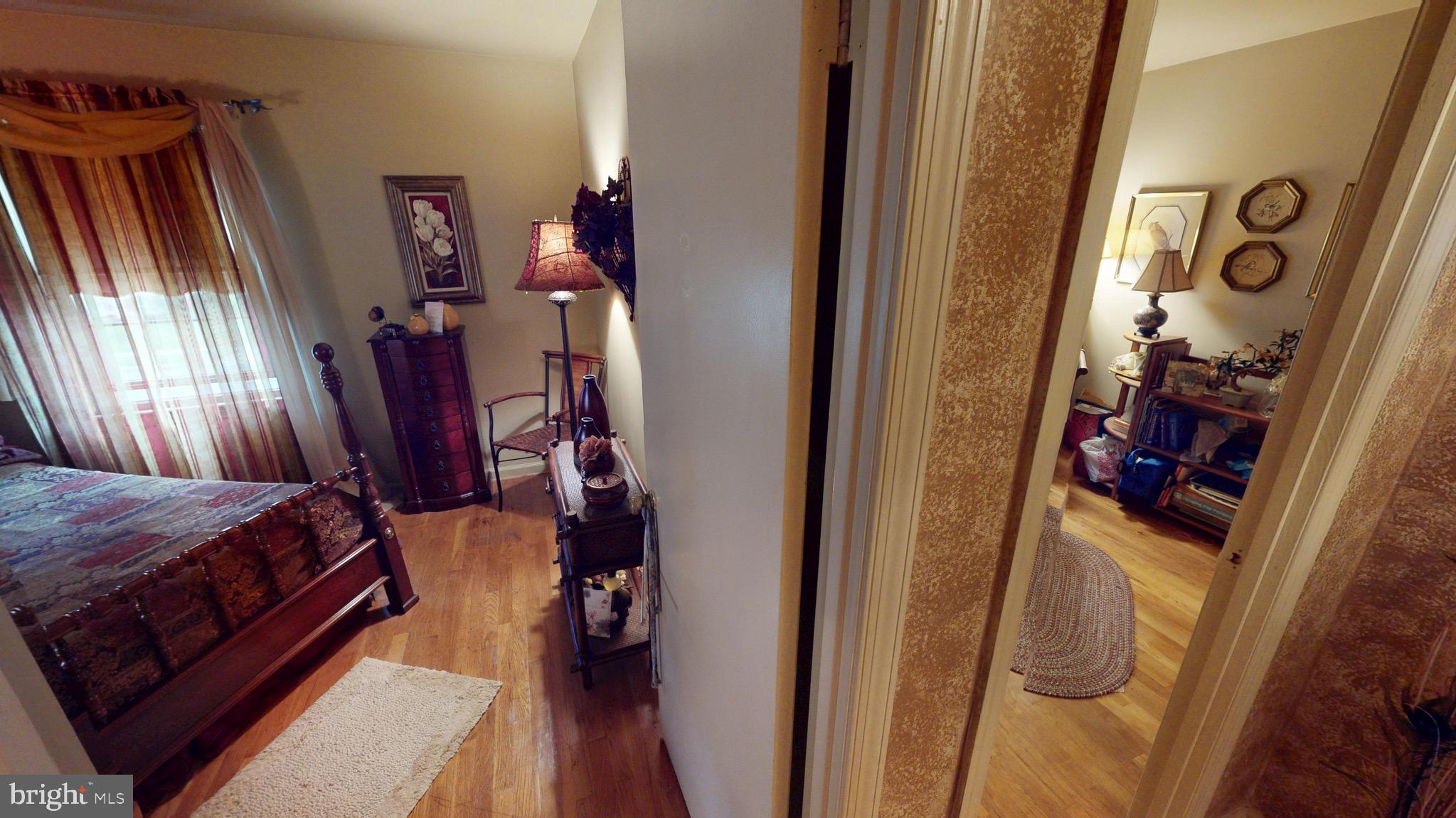 6911 Good Luck Road Hyattsville, MD 20784 - Photo 46 of 94 a bed room with a bed and a mirror