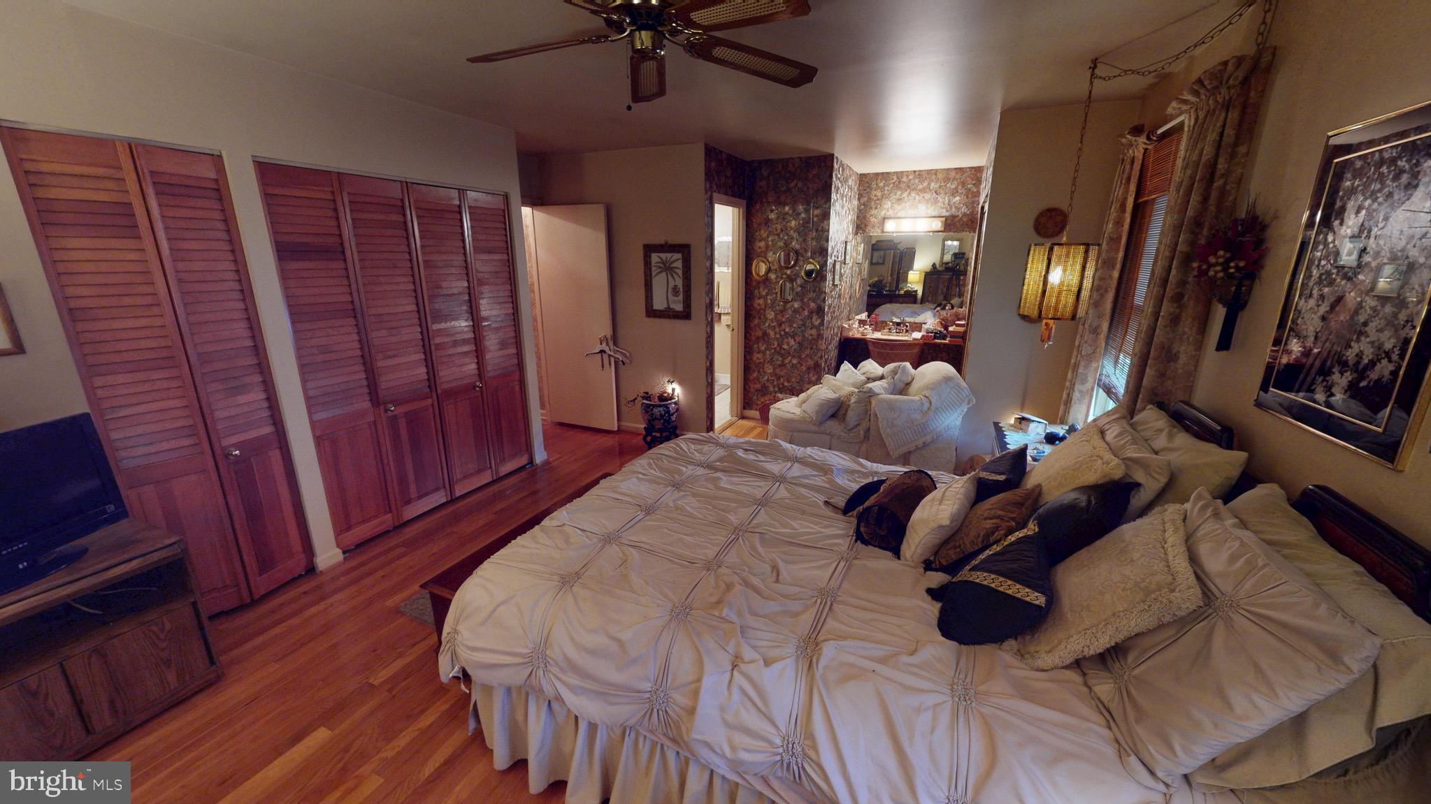 6911 Good Luck Road Hyattsville, MD 20784 - Photo 58 of 94 a bed room with a bed and a mirror