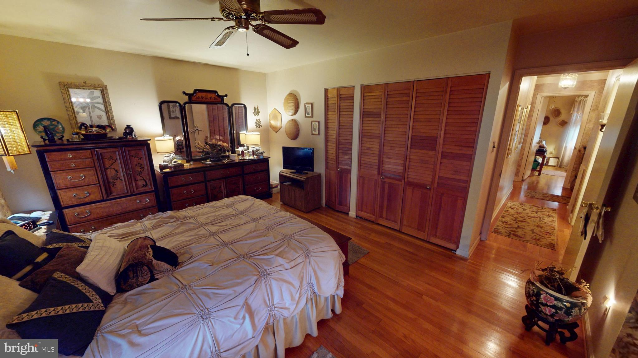 6911 Good Luck Road Hyattsville, MD 20784 - Photo 63 of 94 a bedroom with a bed and a mirror on dresser