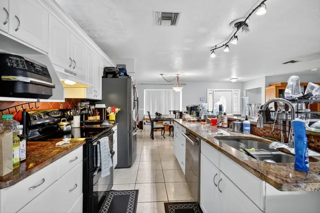 a kitchen with lots of counter top space and a sink