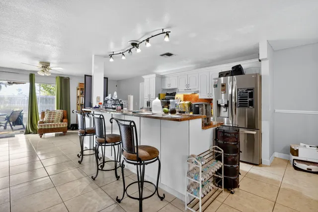 a kitchen with stainless steel appliances a refrigerator and microwave