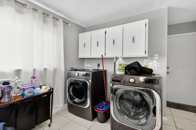 a utility room with sink dryer and washer