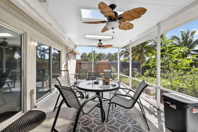 a dining room with furniture a rug and a large window