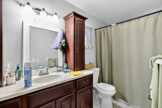 a bathroom with a sink vanity mirror and toilet
