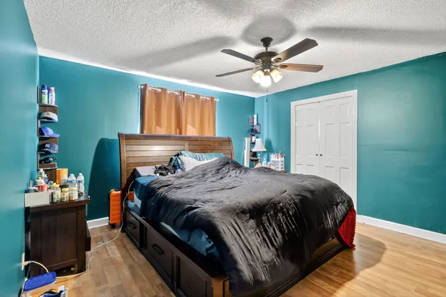 a bedroom with a bed and wooden floor