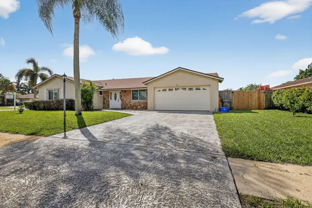 a view of a house with a yard and plants