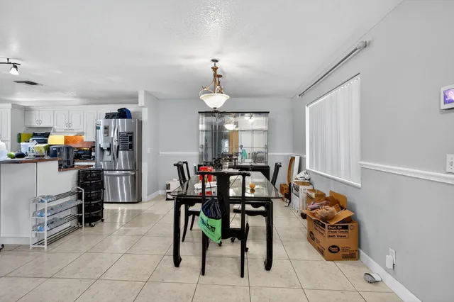 a view of a dining room with furniture and a chandelier